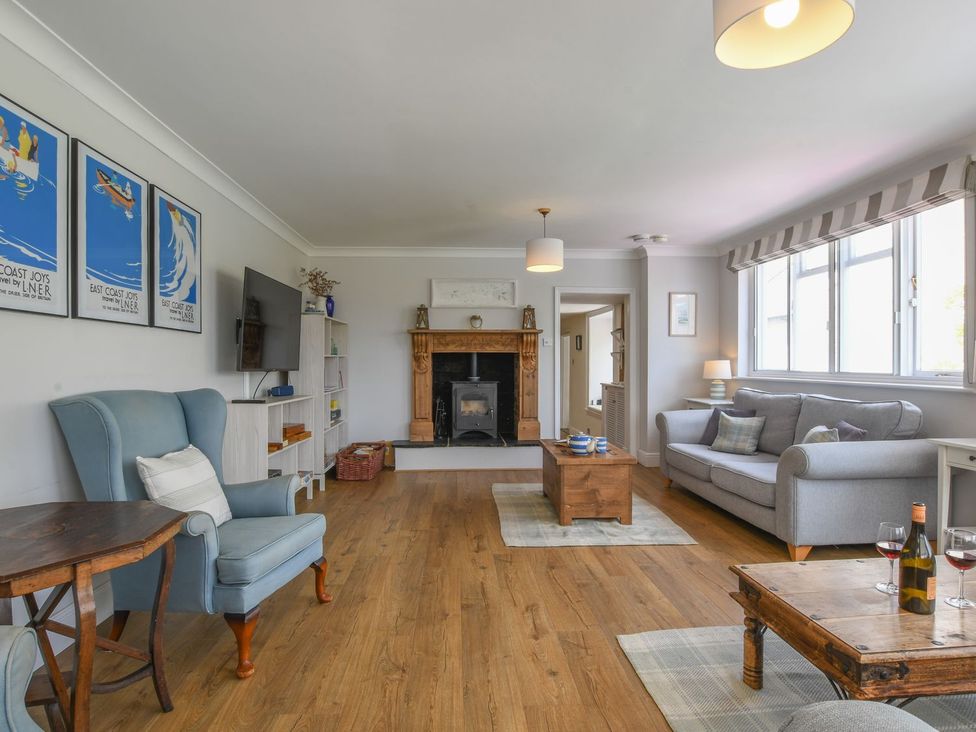 A living room with a fireplace and sofa at Beresford House in Woodbridge
