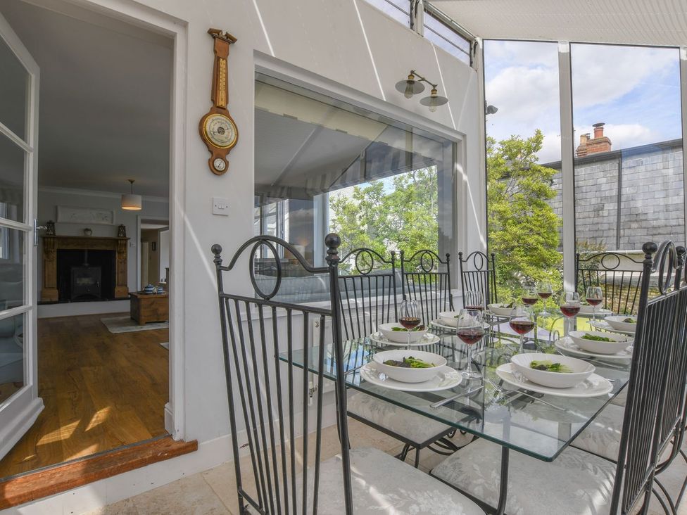 A dining area with a glass table and chairs at Beresford House in Woodbridge