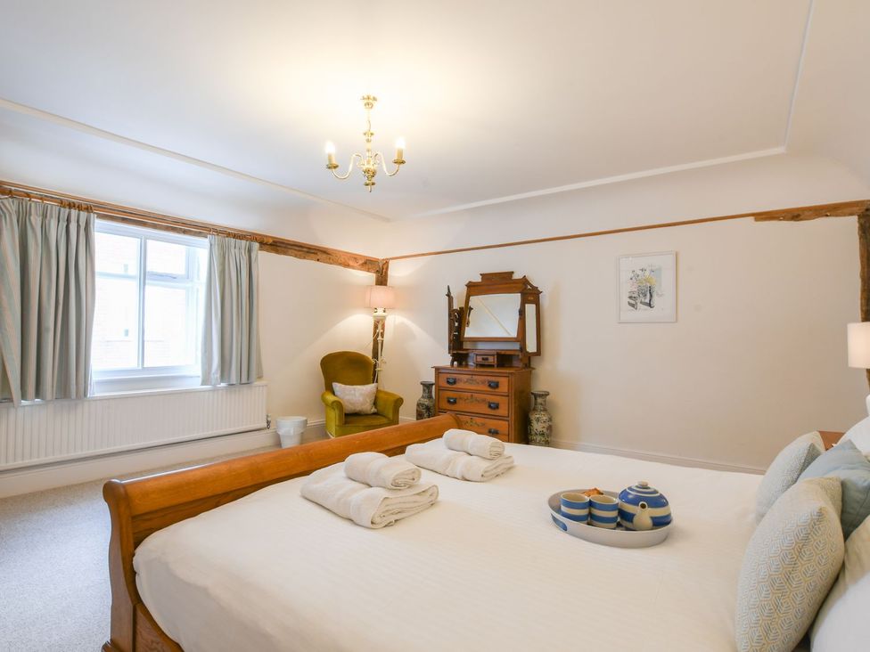 A bedroom with a bed and mirror at Beresford House Woodbridge