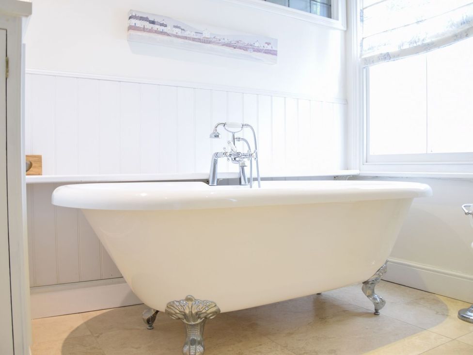 A bathroom with a bathtub and faucet at Beresford House in Woodbridge