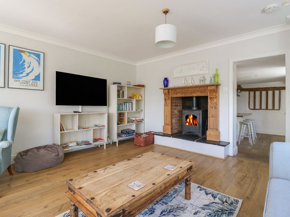 A living room with a fireplace and television at Beresford House in Woodbridge
