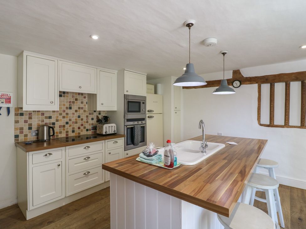 A kitchen with cabinets and appliances at Beresford House in Woodbridge