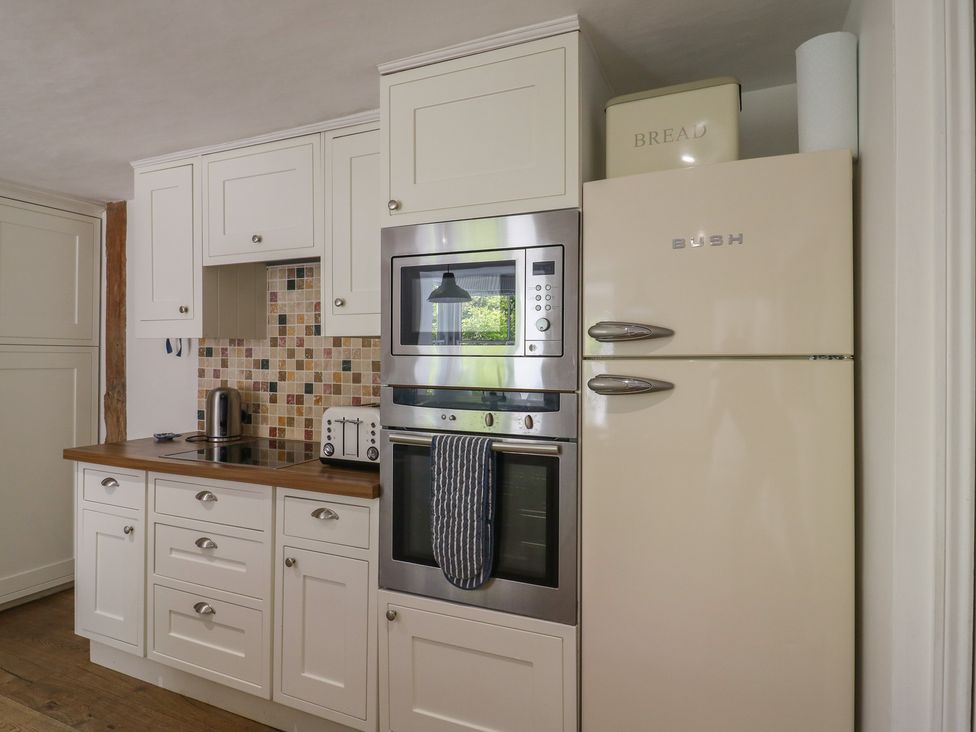 A kitchen with cabinets and appliances at Beresford House Woodbridge