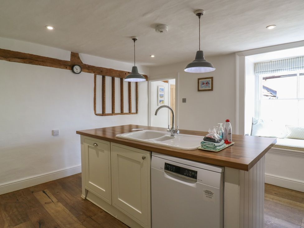 A kitchen with a wooden island and sink at Beresford House in Woodbridge
