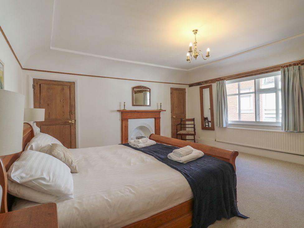 A bedroom with a bed and a chair at Beresford House in Woodbridge