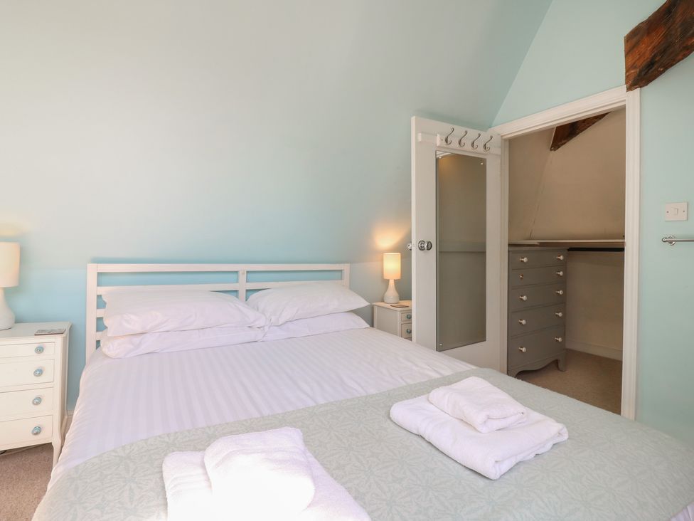 A bedroom with a bed and a nightstand at Beresford House Woodbridge