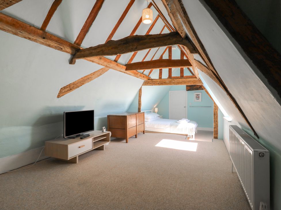 A bedroom with a bed and tv in Beresford House Woodbridge