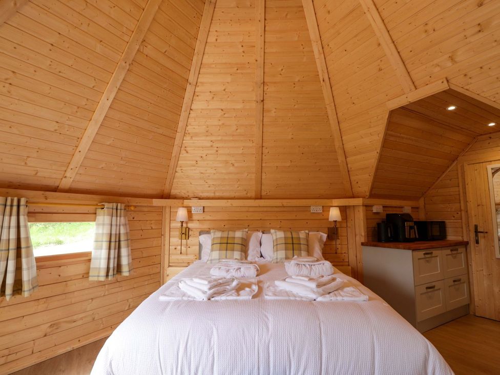 A bedroom with a bed and kitchenette at Little Luxe Lodges 1 in Kyle