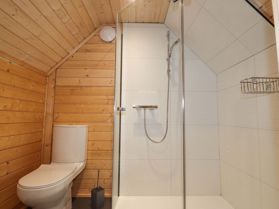 A bathroom with a toilet and shower at Little Luxe Lodges 2 in Kyle