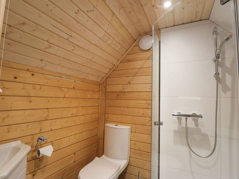 A bathroom with a toilet, sink, and shower at Little Luxe Lodges 2 in Kyle