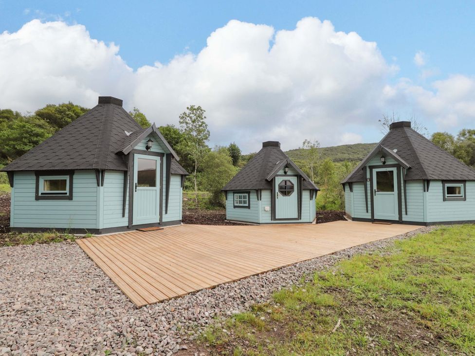 Three cabins with a wooden deck in an outdoor area at Little Luxe Lodges 2 in Kyle