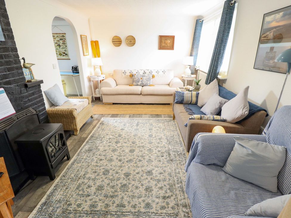 A living room with sofas and a fireplace at Four Seasons in Humberston, Lincolnshire
