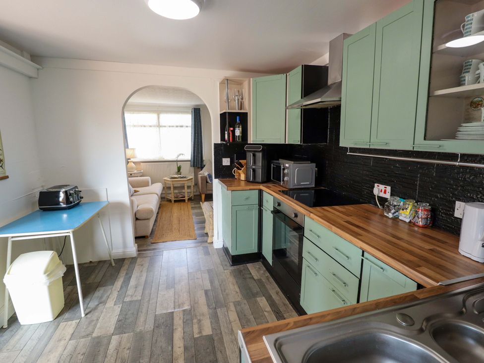 A kitchen with cabinets and appliances at Four Seasons, Humberston, Lincolnshire
