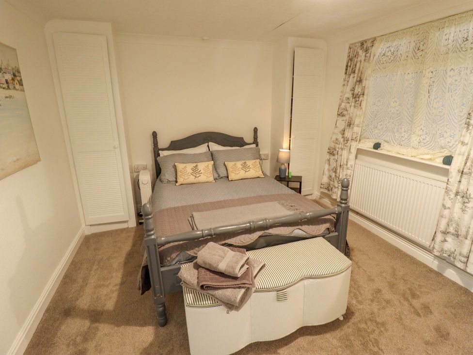 A bedroom with a bed and bedside table at Four Seasons Humberston, Lincolnshire