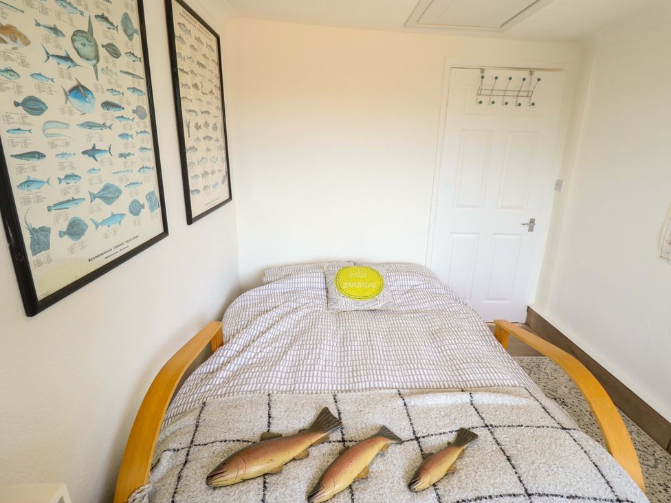 A bedroom with a bed and fish decor at Four Seasons in Humberston, Lincolnshire