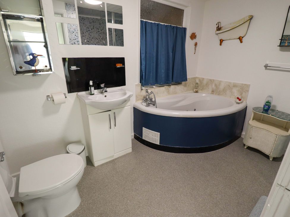 A bathroom with a bathtub and sink at Four Seasons in Humberston, Lincolnshire
