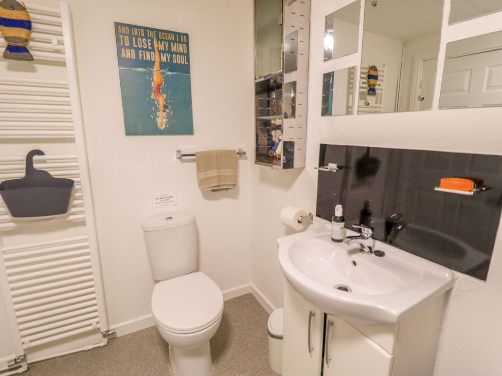 A bathroom featuring a toilet and sink at Four Seasons in Humberston, Lincolnshire