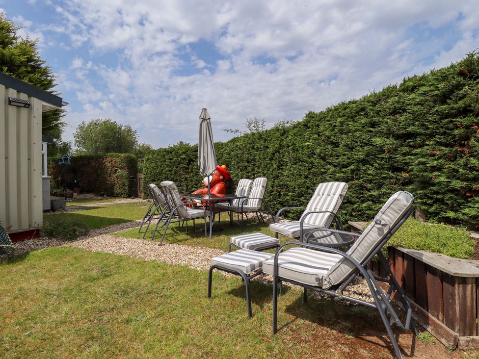 A garden with seating and a table at Four Seasons, Humberston, Lincolnshire