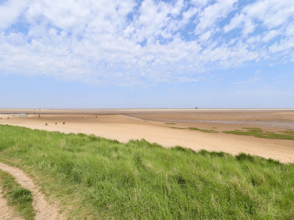 A beach with grass and sand at Four Seasons in Humberston, Lincolnshire