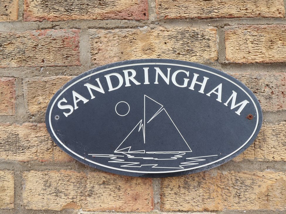 A sign with the name Sandringham and a sailboat illustration at Sandringham in Withernsea