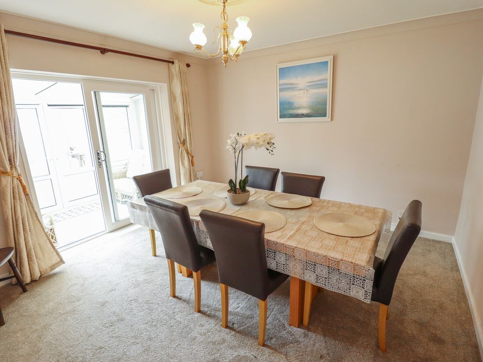 A dining room with a table and chairs at Sandringham in Withernsea