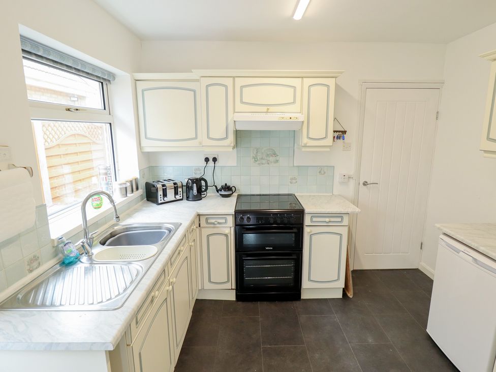 A kitchen with a sink and cooker at Sandringham in Withernsea