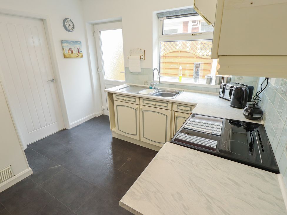A kitchen with a sink and appliances at Sandringham in Withernsea
