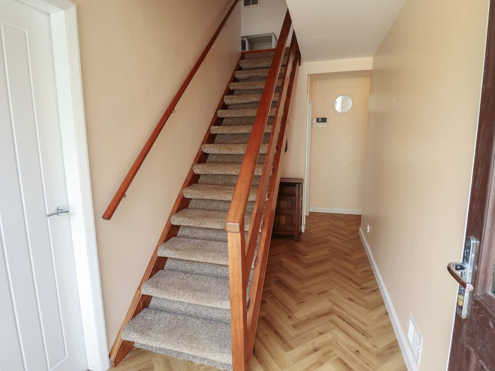A staircase and hallway with a table at Sandringham in Withernsea