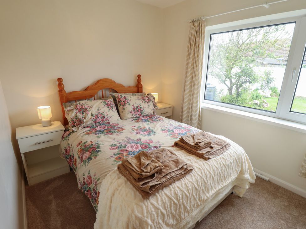 A bedroom with a bed and nightstand at Sandringham in Withernsea