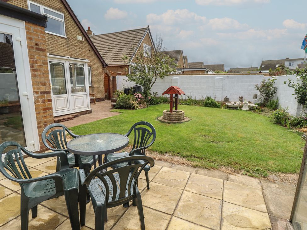 A garden with chairs and a table at Sandringham in Withernsea