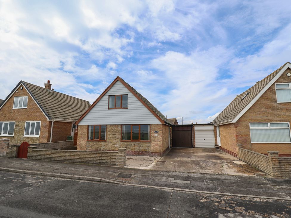 A residential house with a driveway and garage at Sandringham in Withernsea