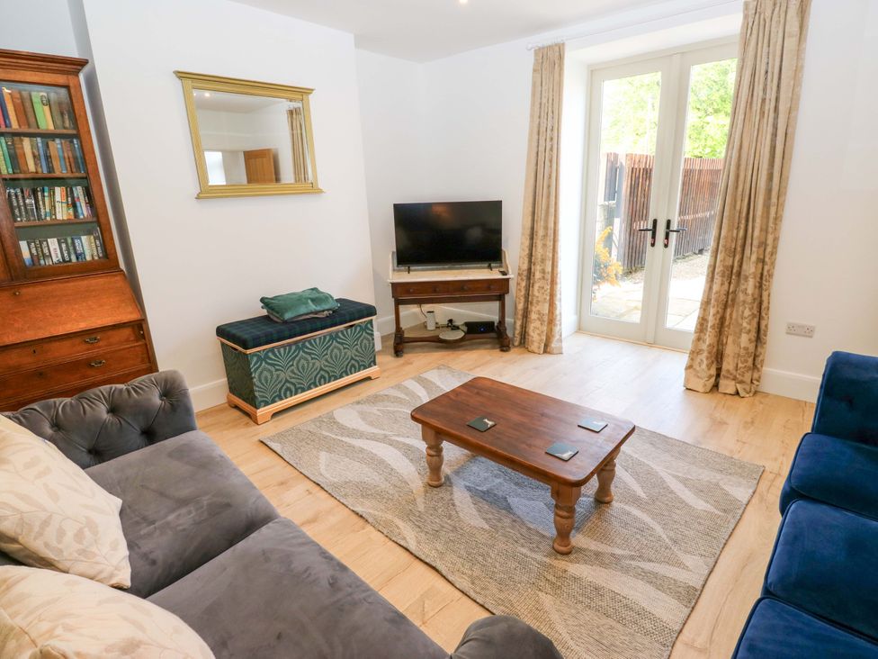A living room with a sofa and television at Stewards House in Tadcaster