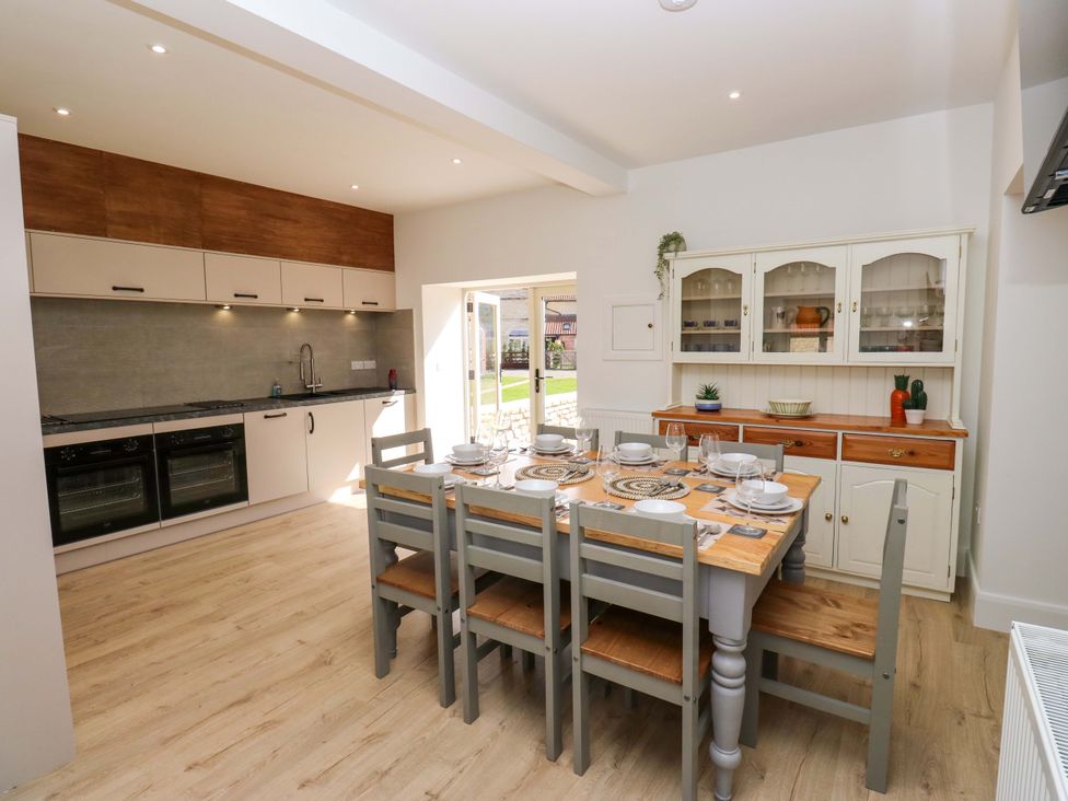 A kitchen with a dining table and chairs at Stewards House in Tadcaster