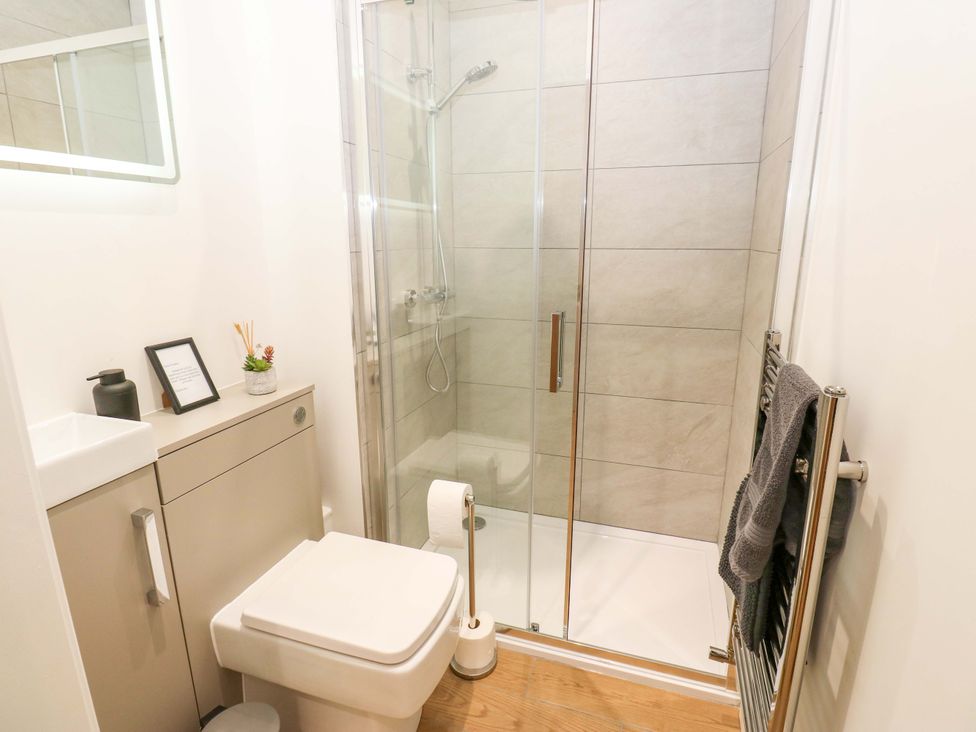 A bathroom featuring a shower, toilet, and vanity at Stewards House in Tadcaster