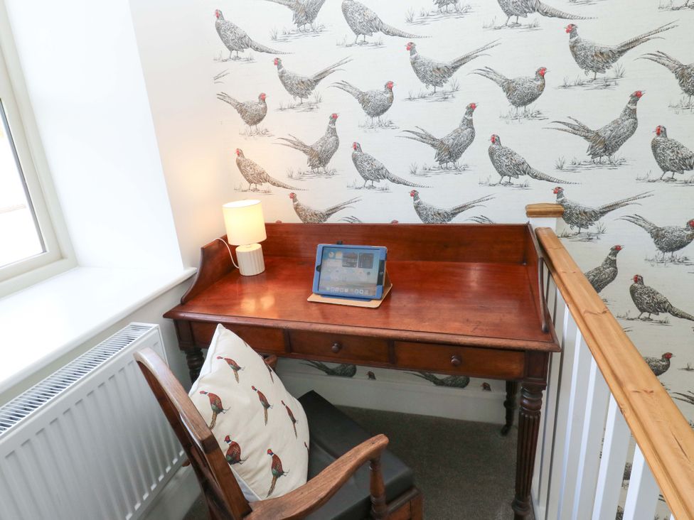 A desk with a lamp and tablet on the landing at Stewards House Tadcaster