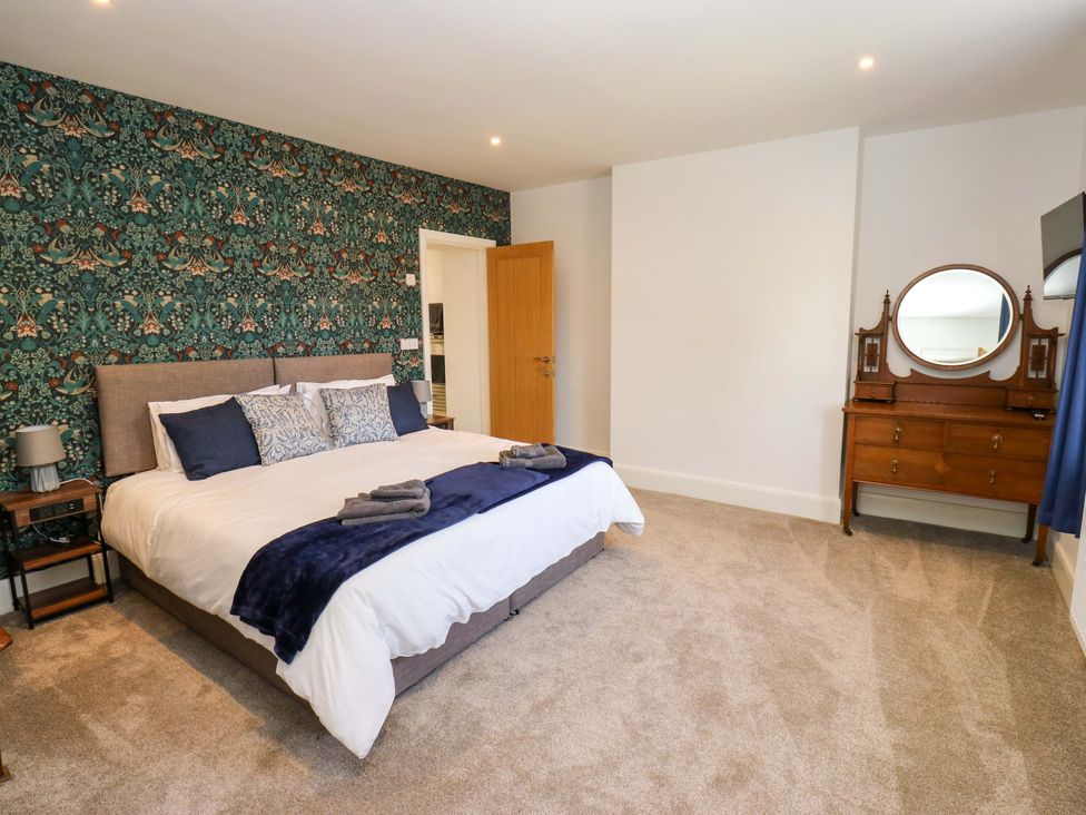 A bedroom with a bed and dresser at Stewards House in Tadcaster