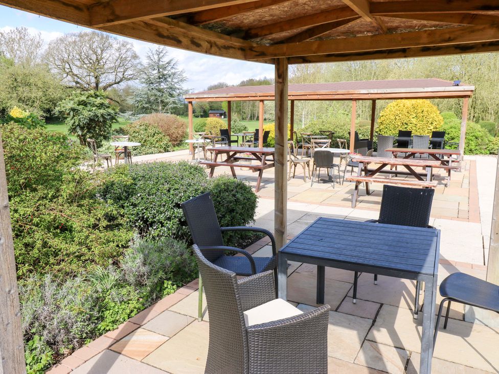 An outdoor seating area with tables and chairs at Stewards House in Tadcaster