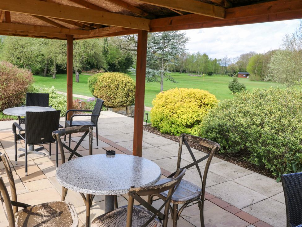 An outdoor seating area with tables and chairs at Stewards House in Tadcaster