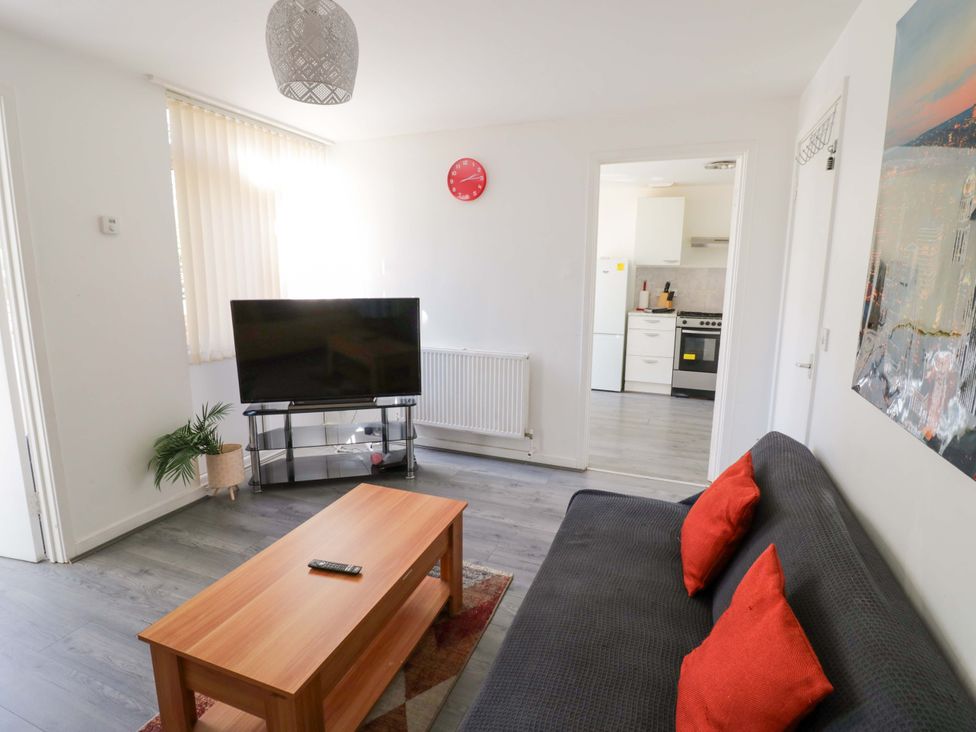 A living room with a television and coffee table at 2 Carpenters Court, Birmingham
