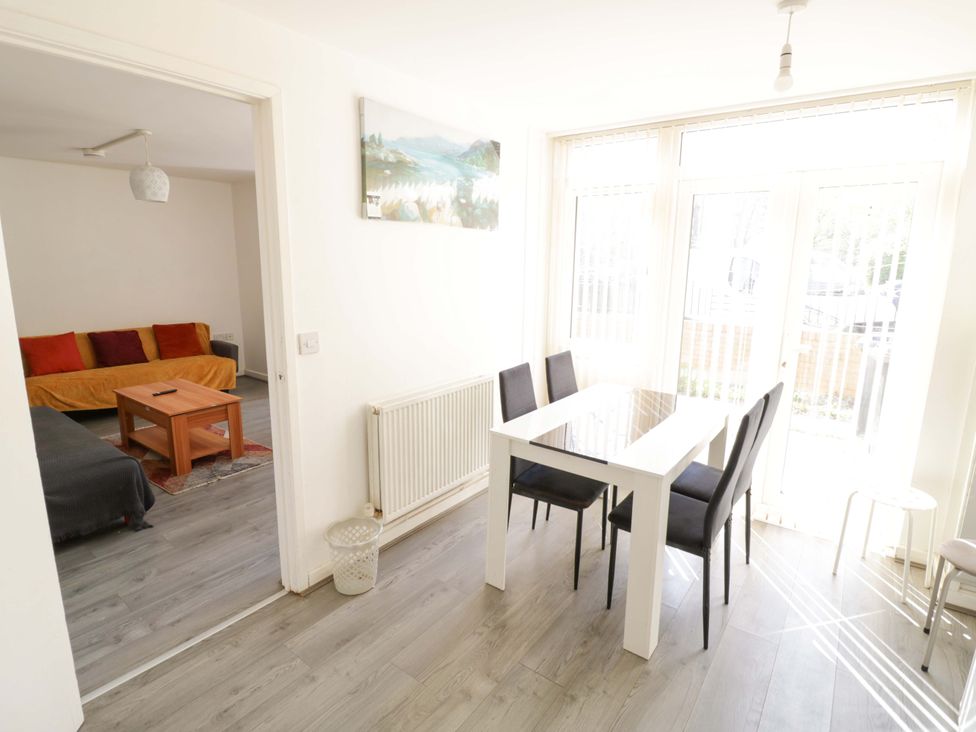 A dining room with a table and chairs at 2 Carpenters Court in Birmingham