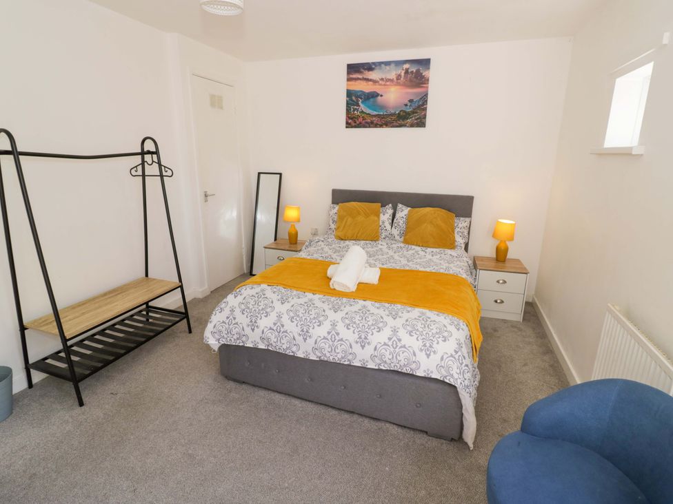 A bedroom with a bed and nightstand at 2 Carpenters Court in Birmingham