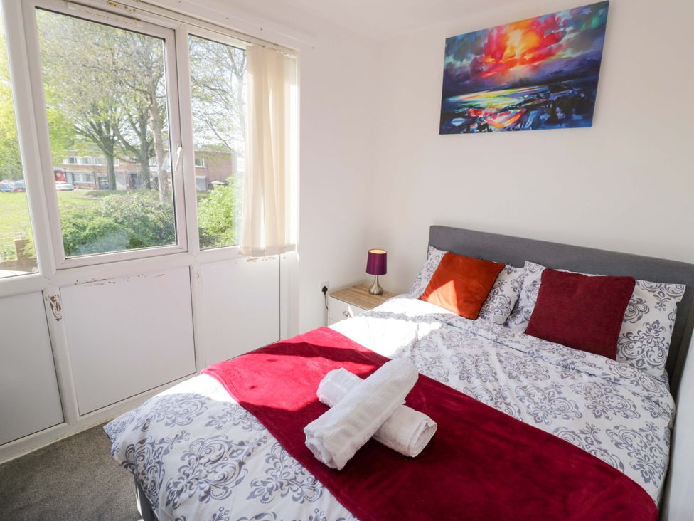 A bedroom with a bed and window at 2 Carpenters Court in Birmingham