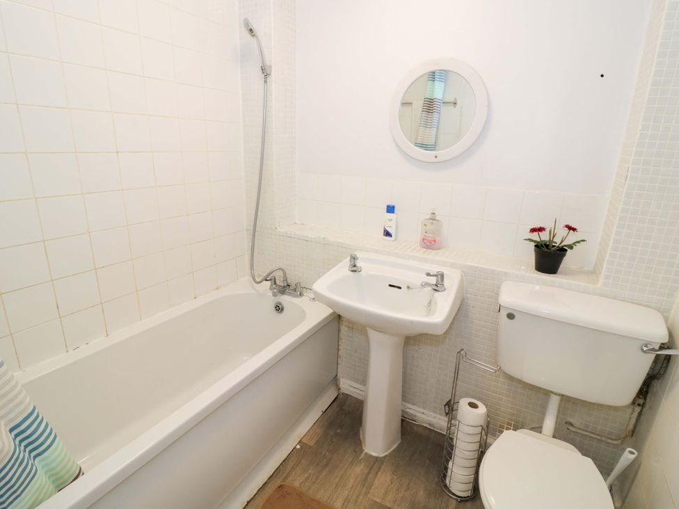 A bathroom with a bathtub, sink and toilet at 2 Carpenters Court in Birmingham