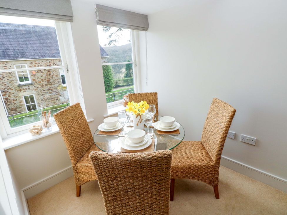 A dining room with a table and chairs at 3 Rhodewood House in Saundersfoot