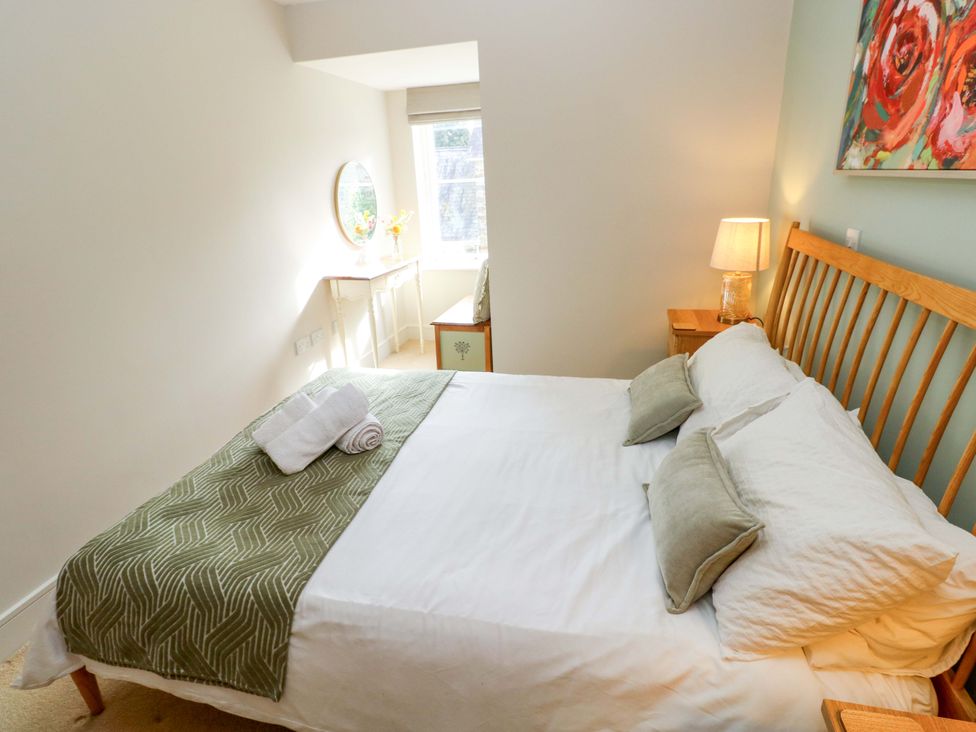 A bedroom with a bed and lamp at 3 Rhodewood House Saundersfoot