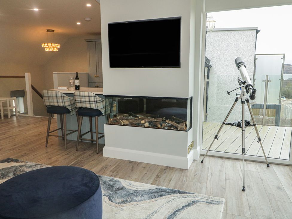 A living room with a fireplace and a telescope at 2 Ard an Chuain Dunfanaghy