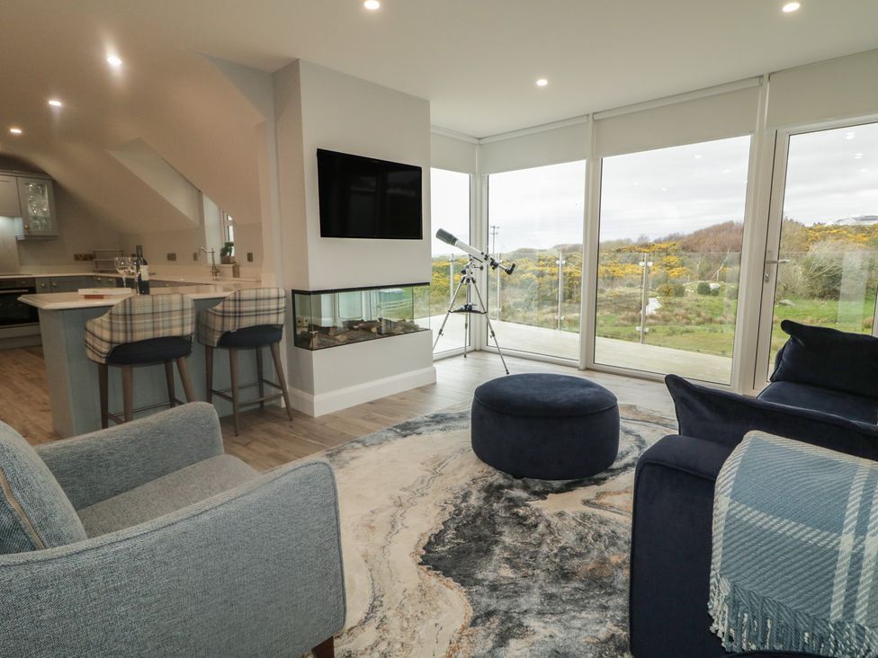 A living room with a television and telescope at 2 Ard an Chuain in Dunfanaghy