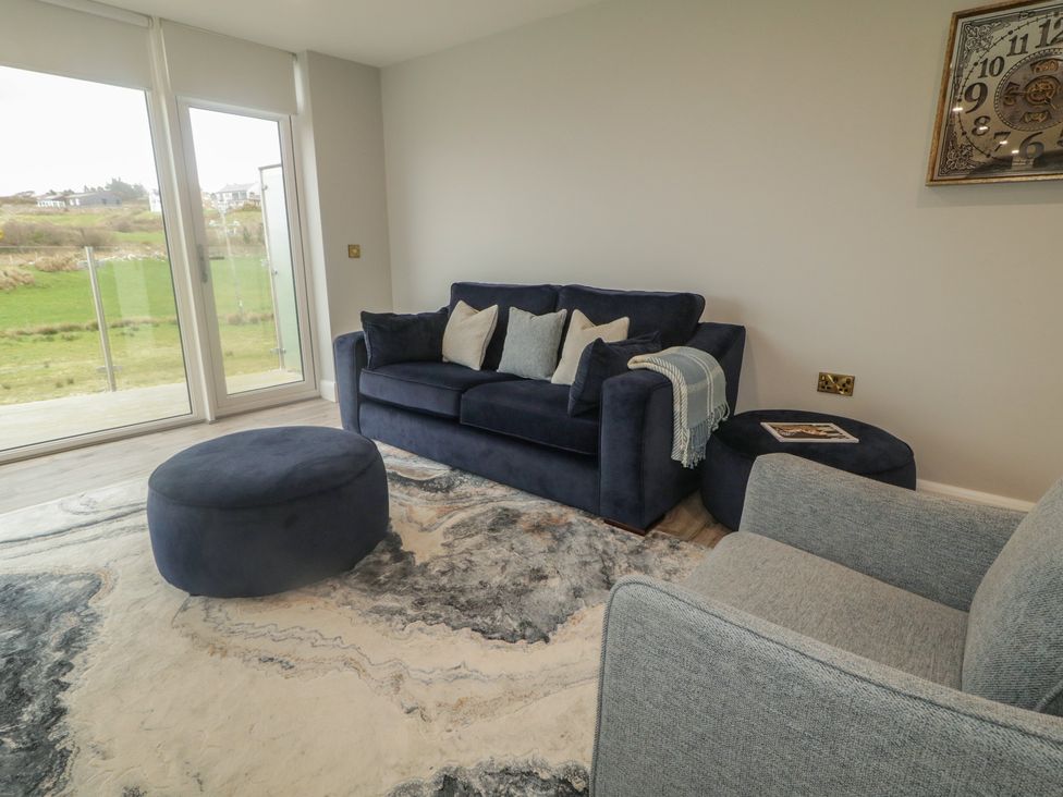 A living room with a sofa and armchair at 2 Ard an Chuain Dunfanaghy