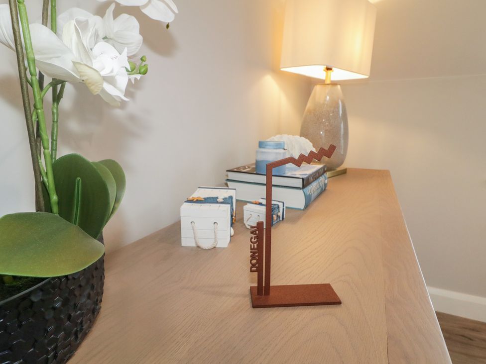 A living room with a decorative object, books, and a plant at 2 Ard an Chuain Dunfanaghy