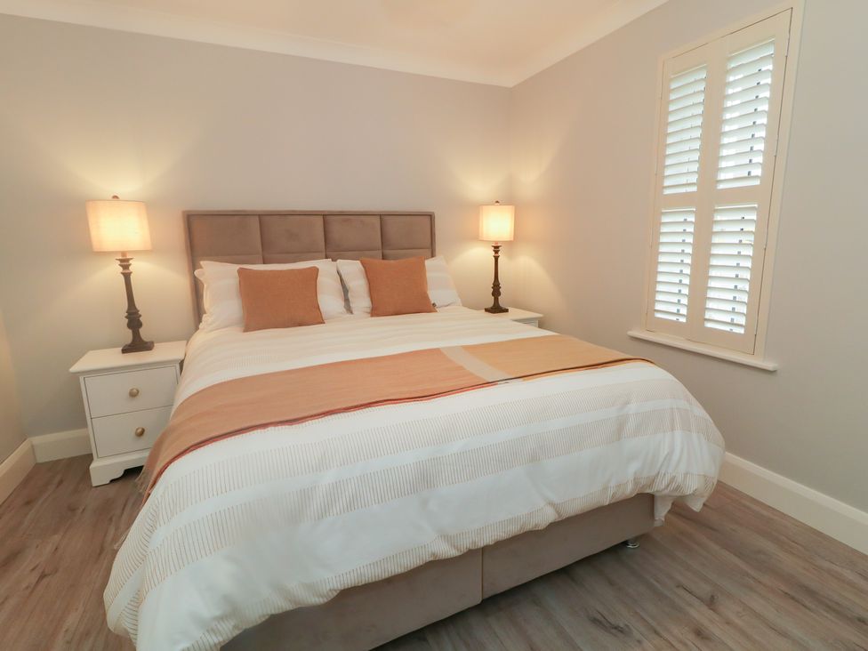 A bedroom with a bed and nightstands at 2 Ard an Chuain Dunfanaghy